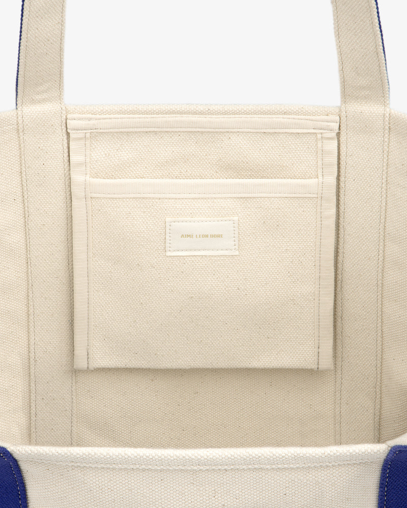 Close-up of the inside of the Krylon Tote Bag, showing a pocket with a small label.