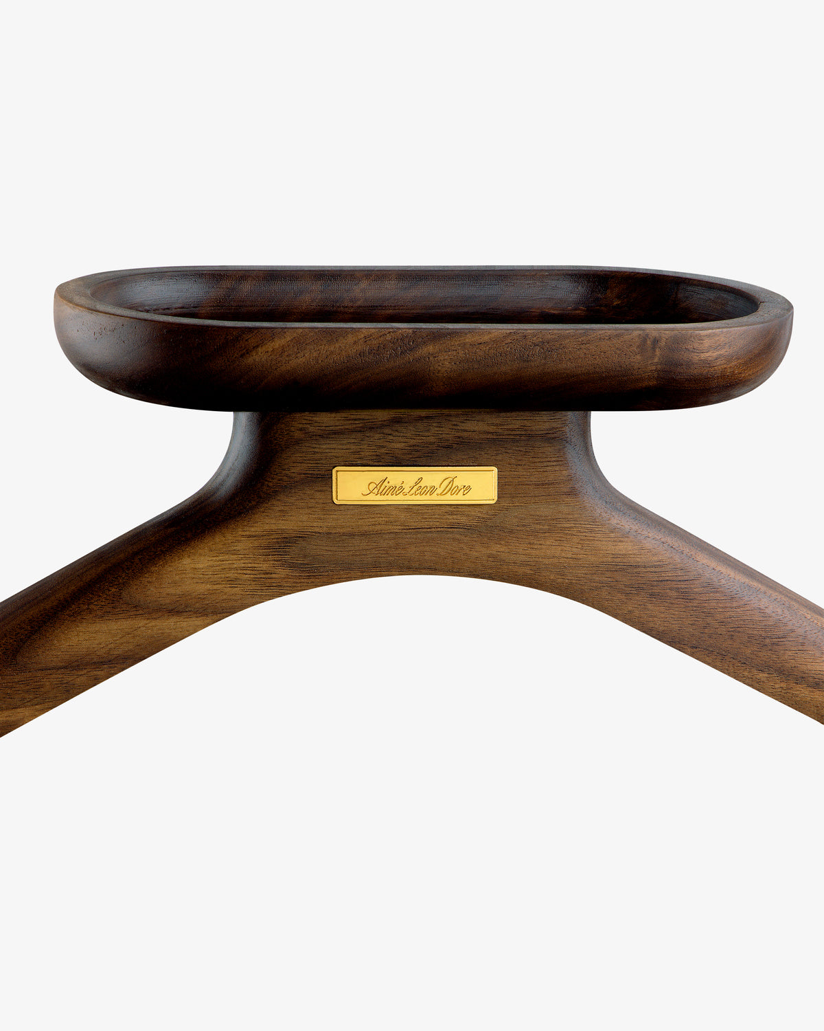 Close-up of the Queens Crest Valet Chair’s dark wooden hanger with a gold nameplate on a white background.