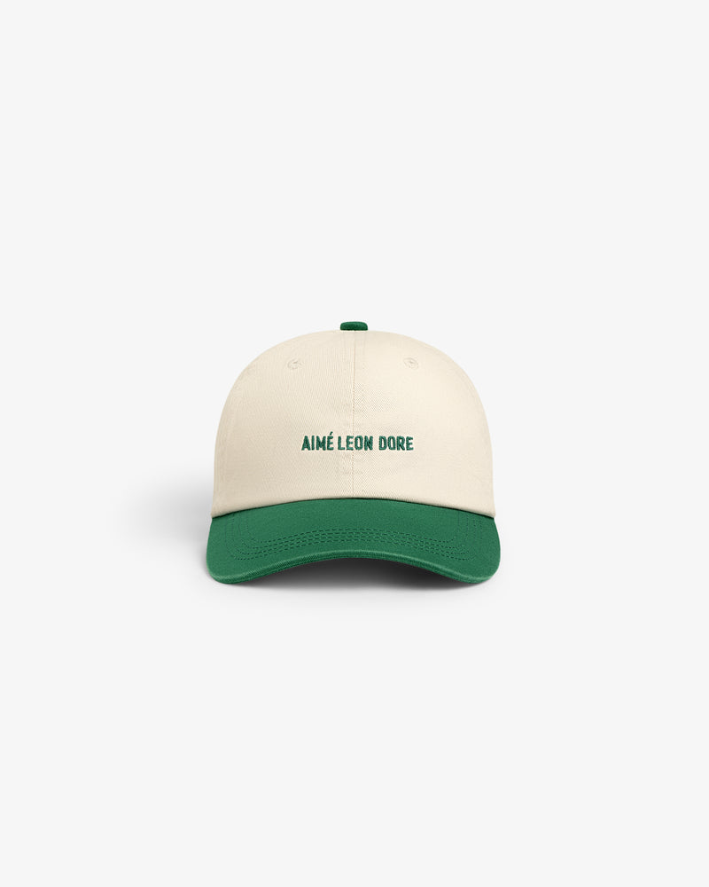 Washed Chino Hat in cream with green brim and AIMÉ LEON DORE embroidered in green on the front.