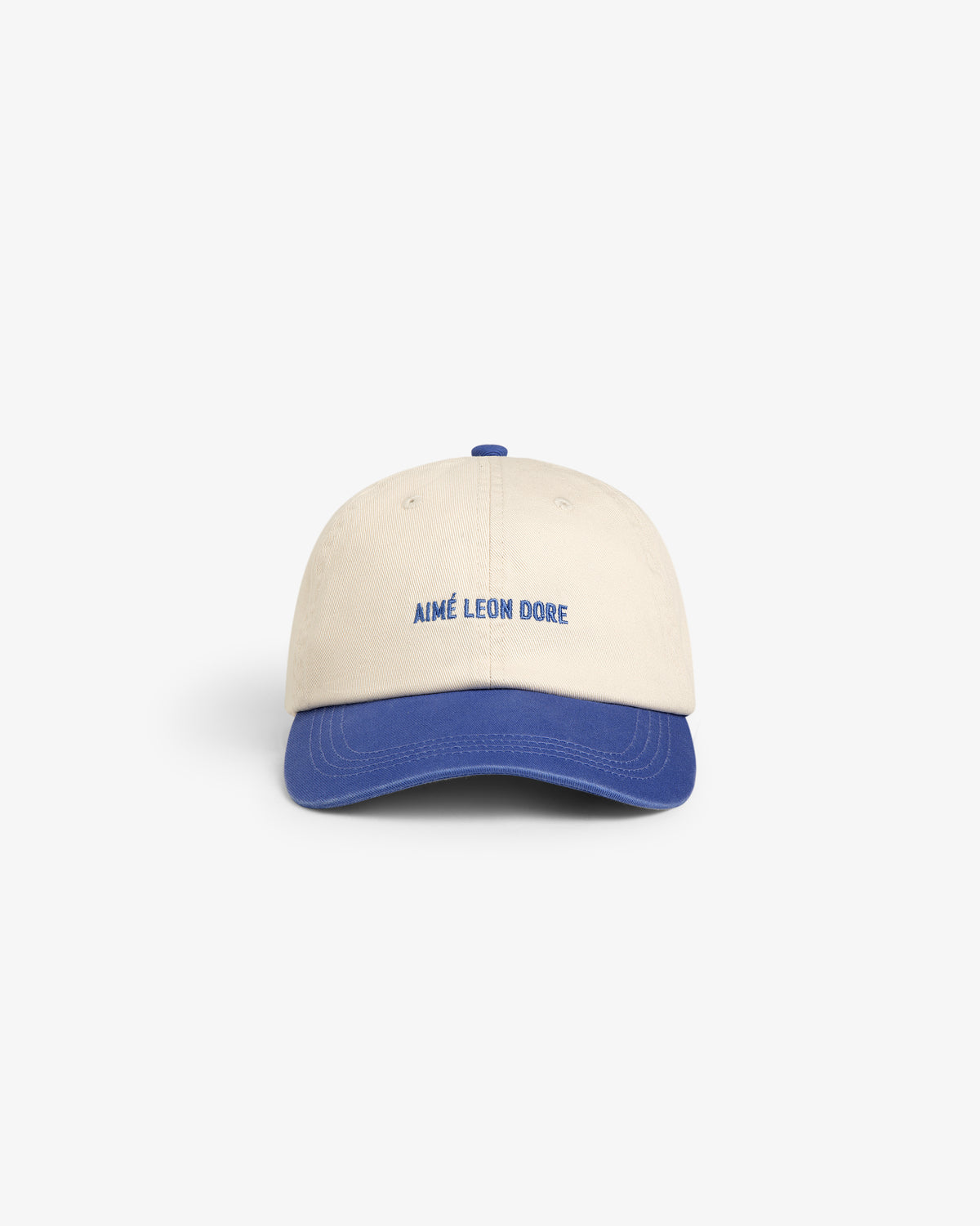 Washed Chino Hat: Beige cap with blue brim, AIMÉ LEON DORE embroidered in blue on the front.