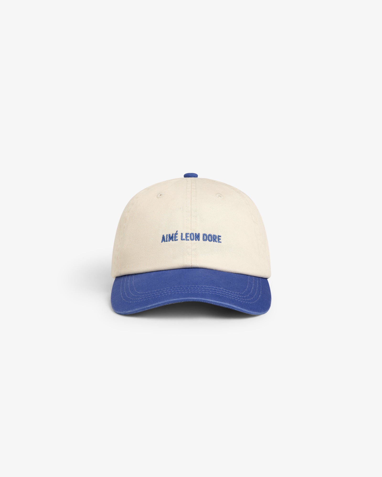 Washed Chino Hat: Beige cap with blue brim, AIMÉ LEON DORE embroidered in blue on the front.