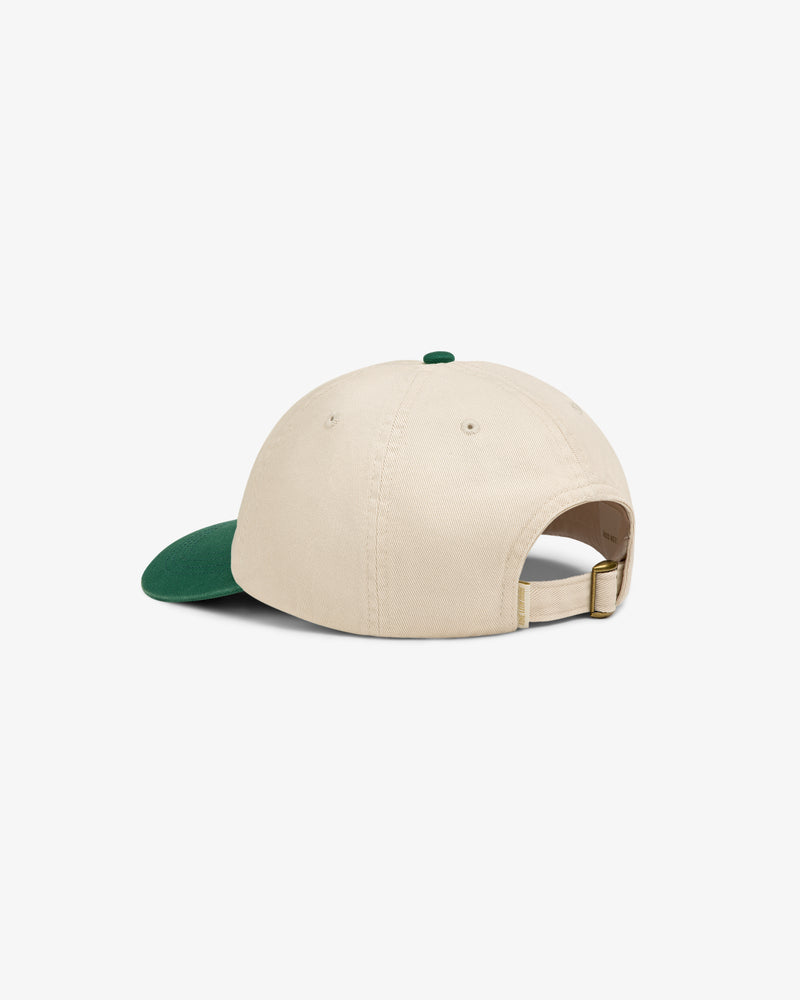 Washed Chino Hat in beige with green bill, shown from back featuring adjustable strap and brass buckle.