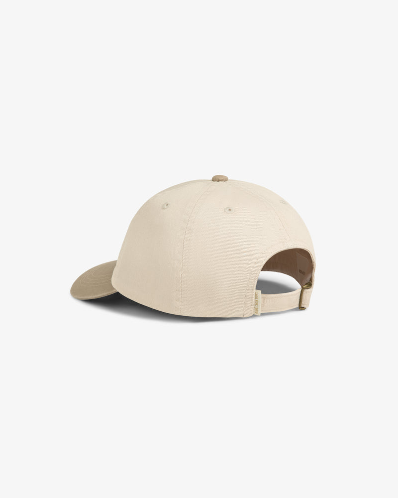 Washed Chino Hat in beige, shown from the back with adjustable strap and curved brim on a white background.