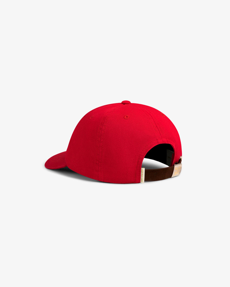 The Crest Logo Hat in red, shown from the back with an adjustable brown strap and metal buckle.