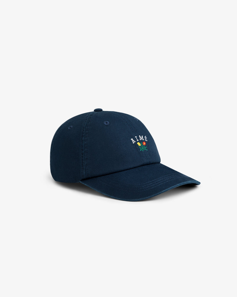 Crest Logo Hat in navy blue with small embroidered text and a flower graphic on the front.
