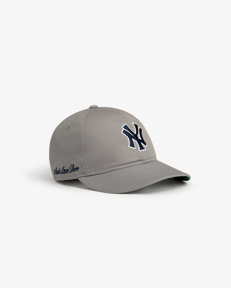 ALD / New Era Yankees Retro Fit Hat in gray with navy Yankees logo and “Slow Love Dove” embroidered on the side.
