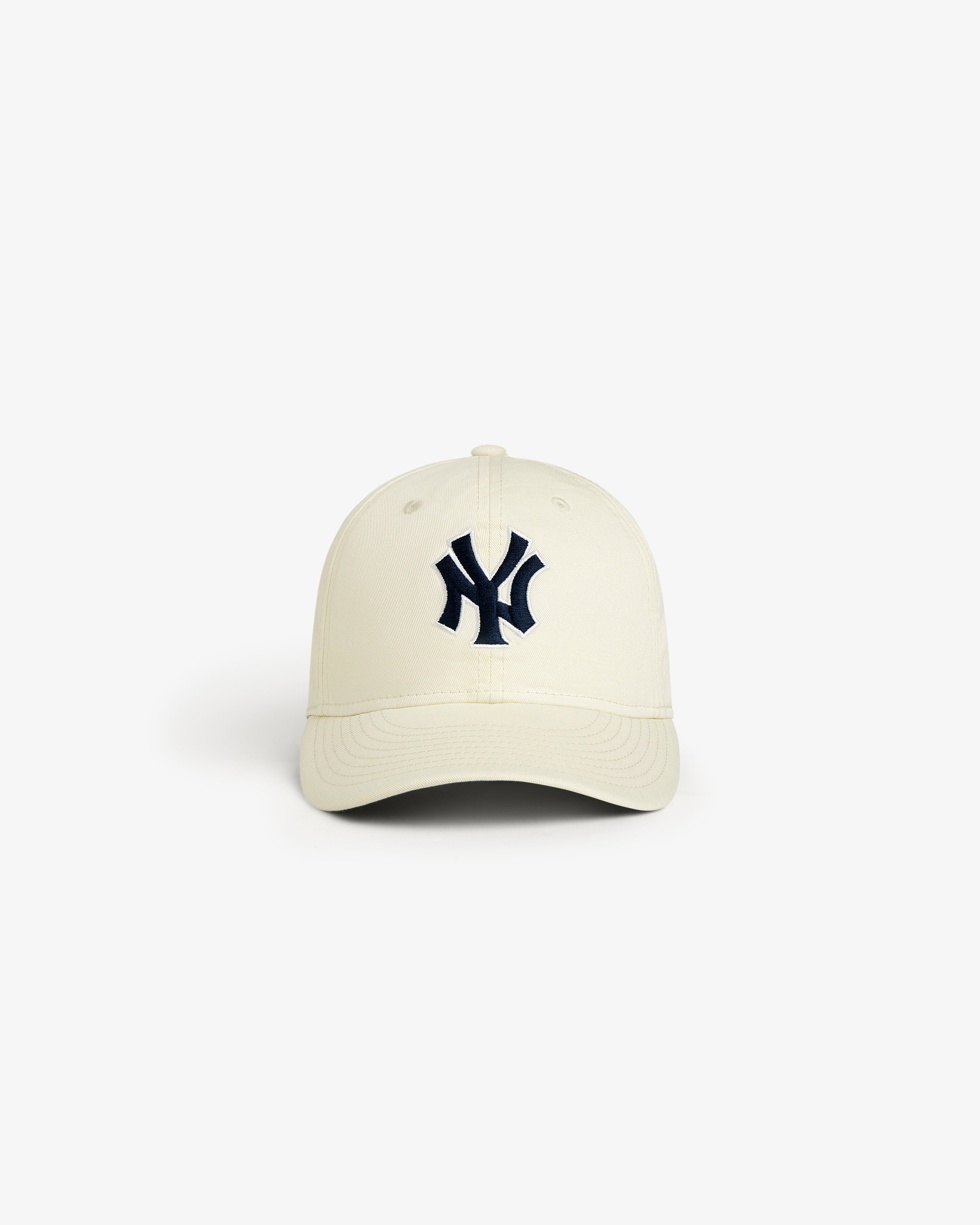 The ALD / New Era Yankees Retro Fit Hat is cream with a dark blue NY logo, displayed on a plain white background.