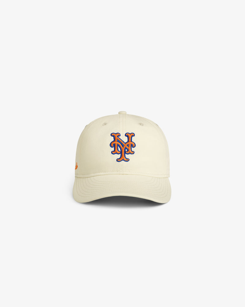 ALD / New Era Mets Retro Fit Hat in cream with blue and orange NY logo, displayed on a white background.