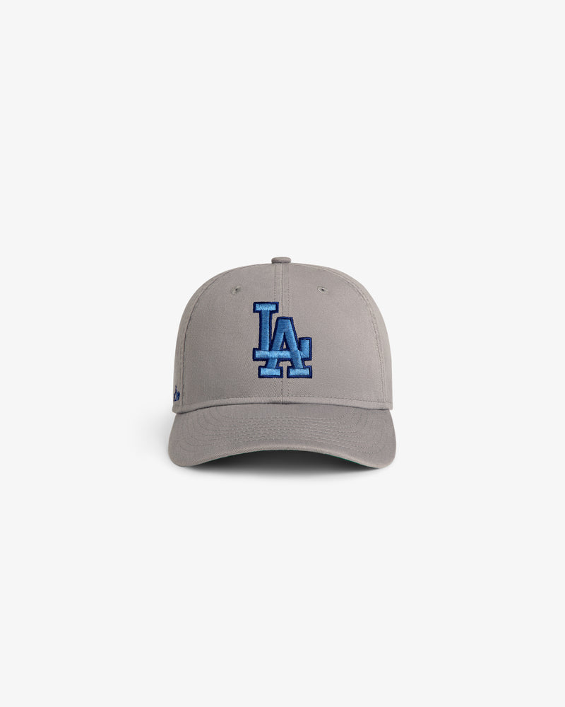 ALD / New Era Dodgers Retro Fit Hat in gray with blue LA logo, displayed on a white background.