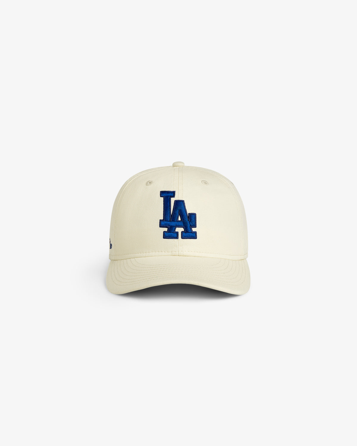 ALD / New Era Dodgers Retro Fit Hat in cream with blue LA logo, shown on a plain white background.