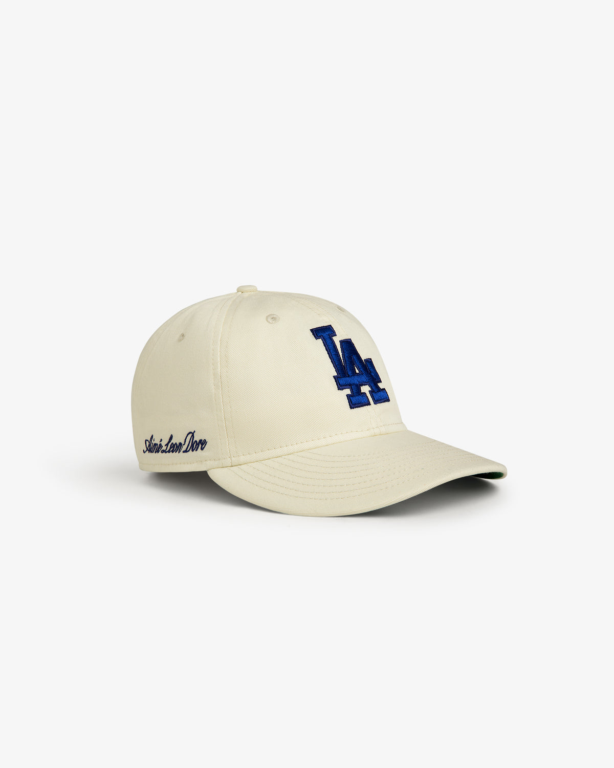 ALD / New Era Dodgers Retro Fit Hat: Beige cap with blue LA logo and Aimé Leon Dore embroidered on the side.