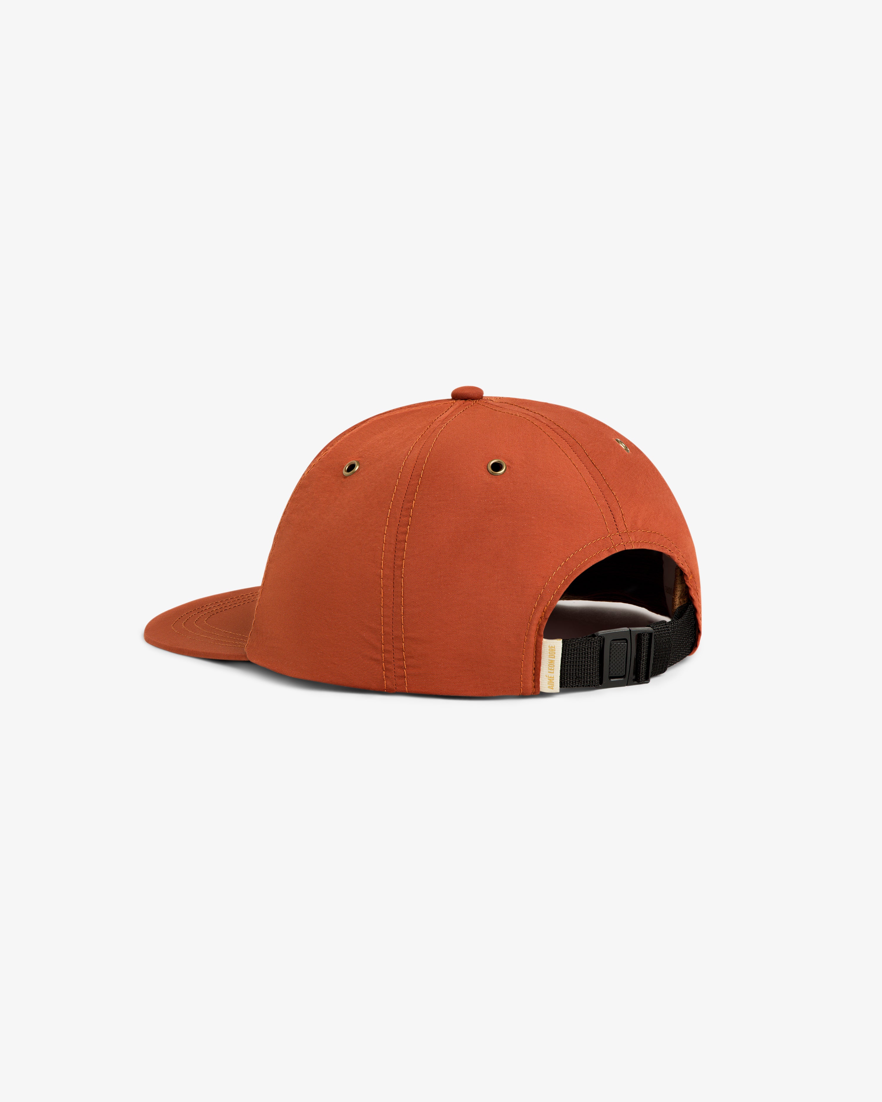 Back view of the Script Sport Hat in orange with adjustable black strap and metal buckle on a white background.