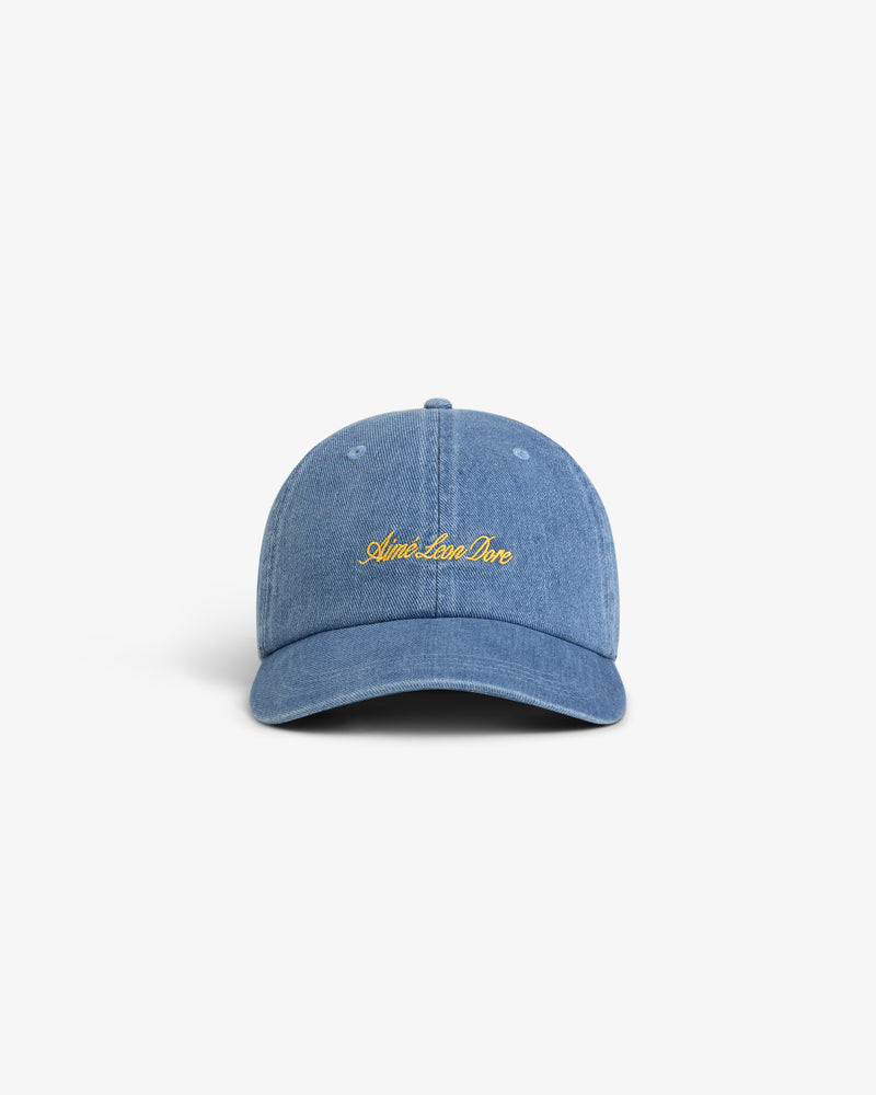 The Denim Script Hat is a light blue denim cap with yellow Aimé Leon Dore embroidery on the front, shown on white.