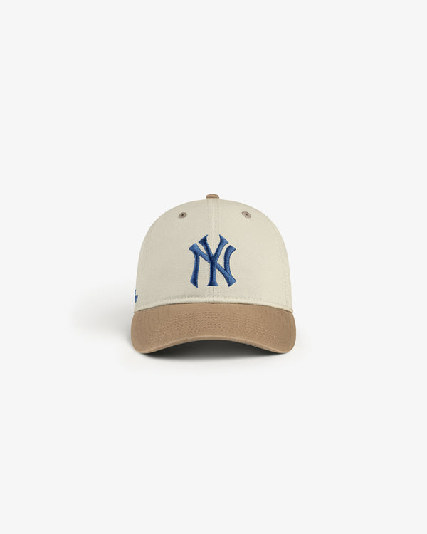 ALD / New York Yankees Colorblock Ballpark Hat with beige crown, brown brim, and blue NY logo on white background.