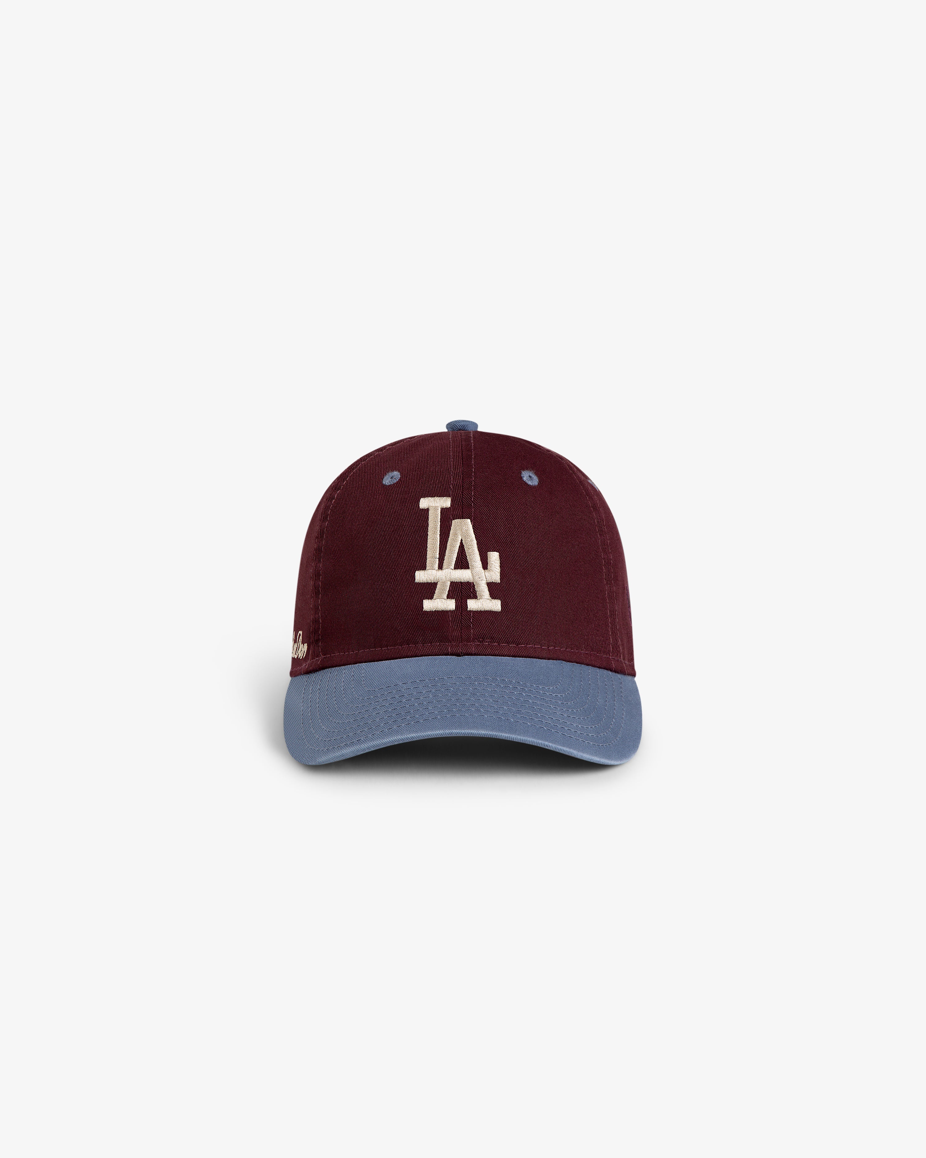 The ALD / LA Dodgers Colorblock Ballpark Hat features a maroon crown, LA logo, and light blue brim.