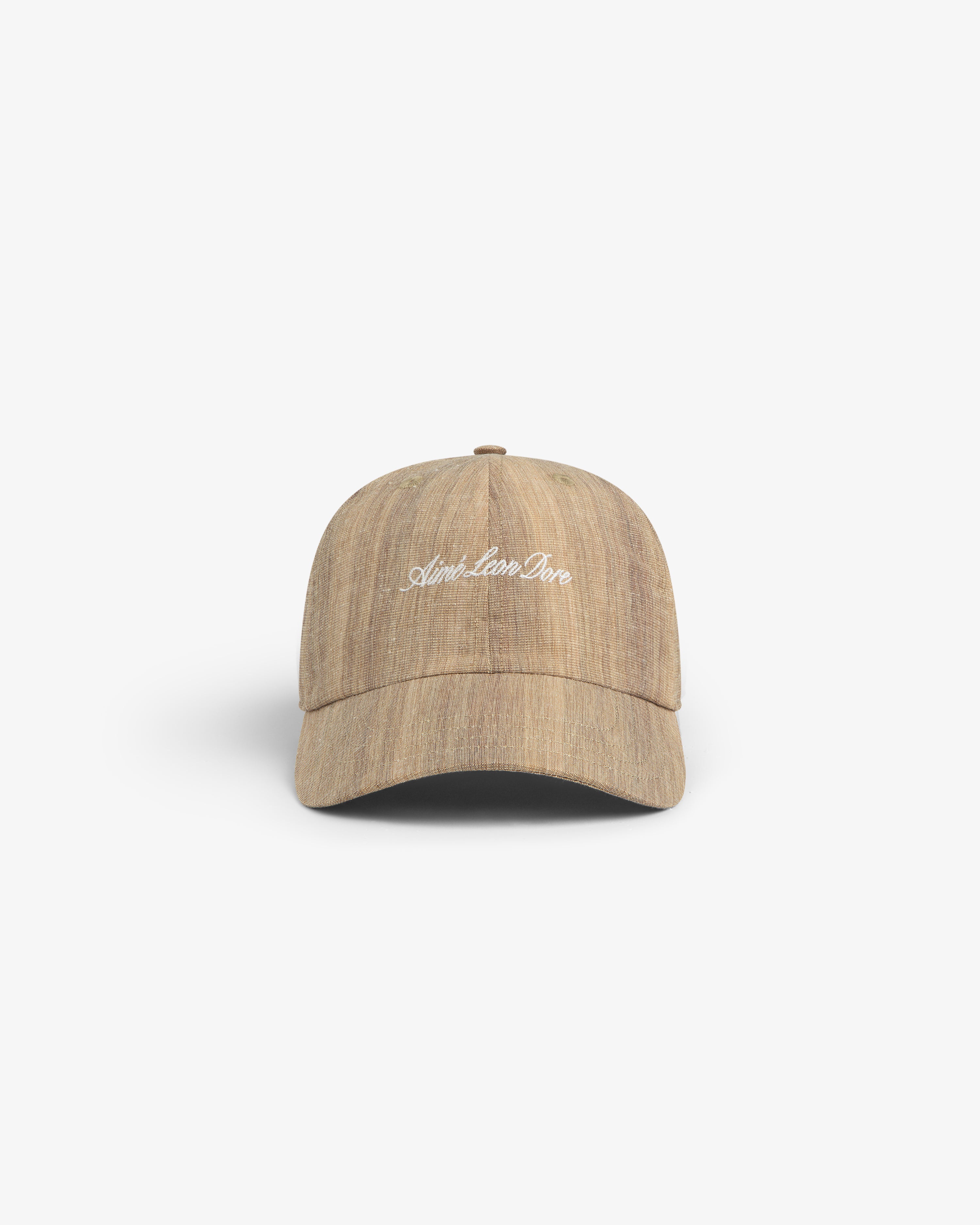 Safari Heritage Hat: Light brown textured baseball cap with "April. Lose. One" in white embroidery on the front.