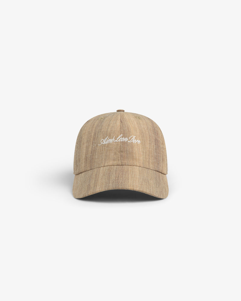 Safari Heritage Hat: Light brown textured baseball cap with "April. Lose. One" in white embroidery on the front.