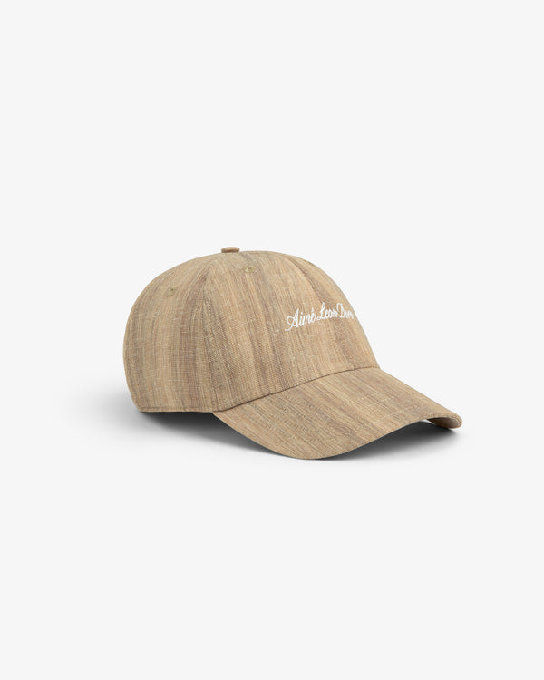 Safari Heritage Hat: light brown textured baseball cap with curved brim and white embroidered text on front.