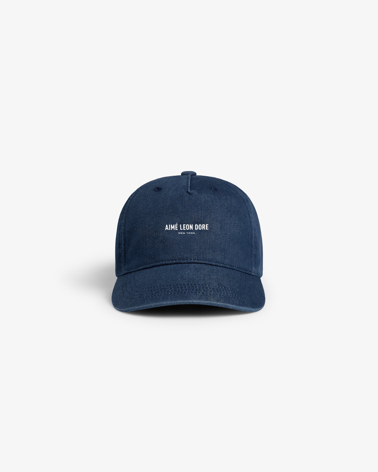 Vintage Micro Logo Hat in navy blue with white AIMÉ LEON DORE text on the front, displayed on a white background.
