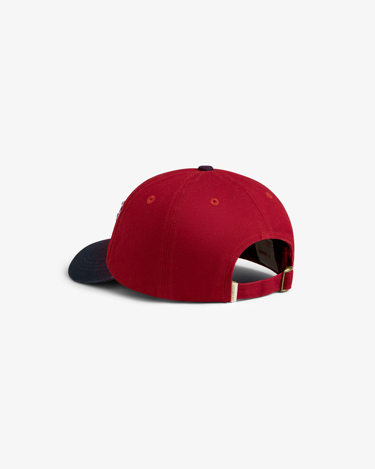 Cycling Logo Hat in red with navy blue brim, shown from the back with adjustable strap and gold buckle.