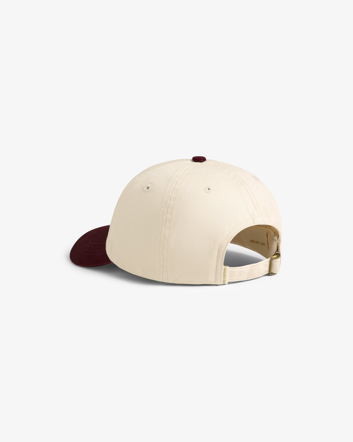 Cycling Logo Hat: cream cap with maroon brim, shown from the back with adjustable strap and metal buckle.