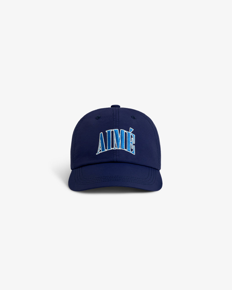 Navy blue Nylon Crusher Hat with AIMÉ embroidered in blue and white on the front, shown on a white background.