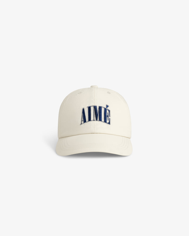 Nylon Crusher Hat in off-white with AIMÉ embroidered in large navy letters on the front, front view.