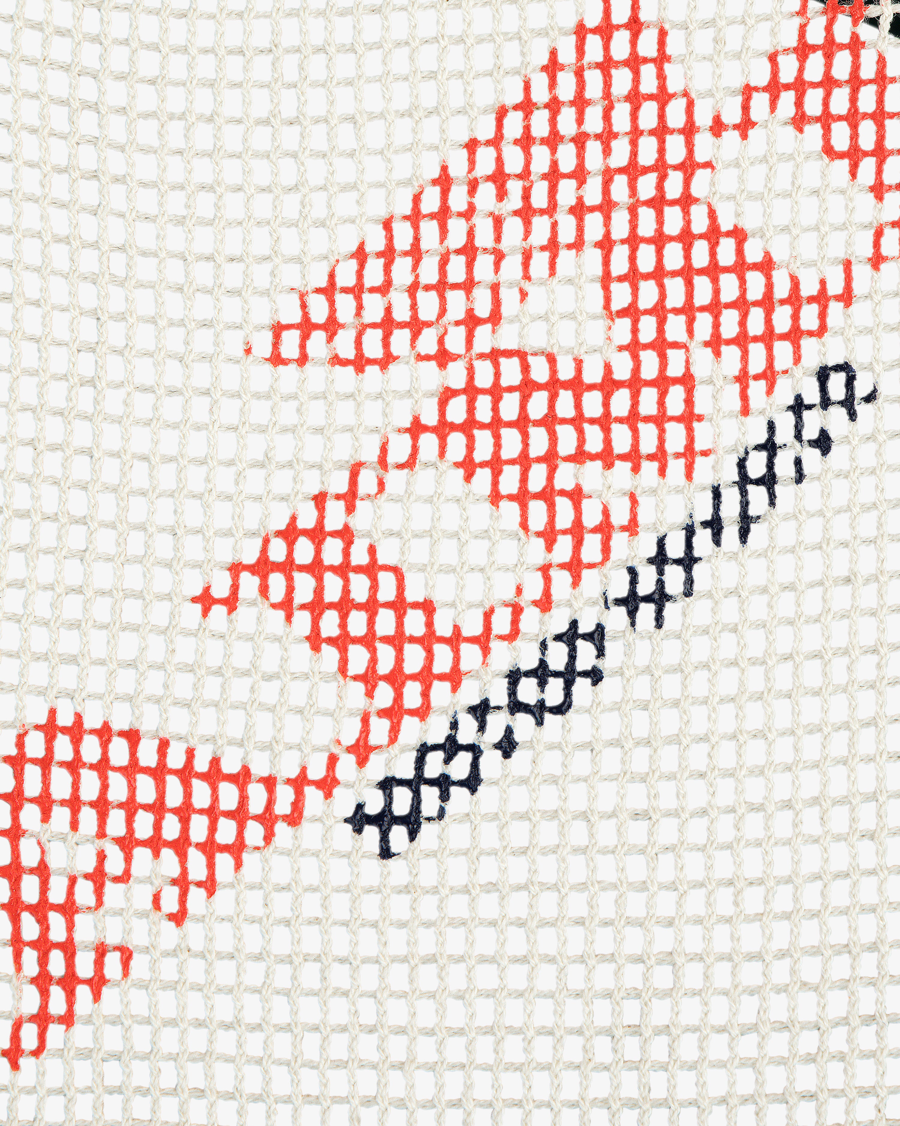 Close-up of Aimé Painters Hat showing red and black stitched letters on white grid mesh fabric.