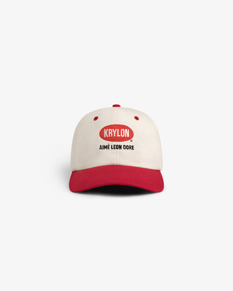 Krylon Logo Hat in cream and red with KRYLON and AIMÉ LEON DORE text, shown on a white background.