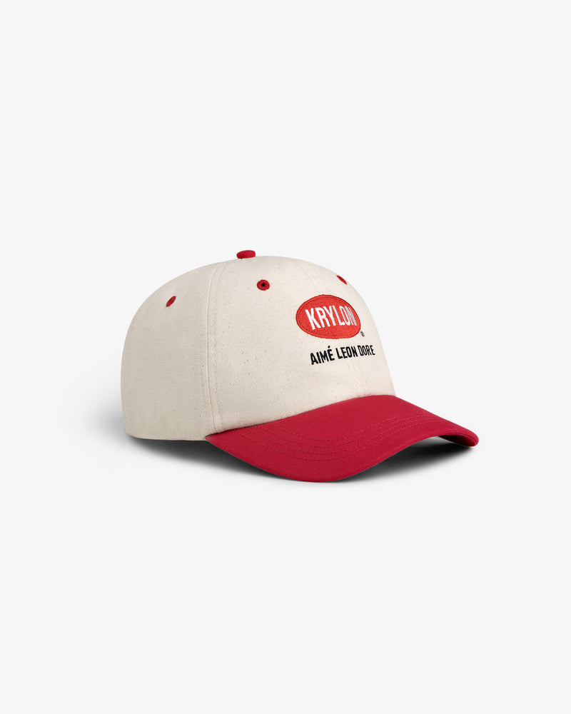 Beige and red Krylon Logo Hat with KHYLLO and AIMÉ LEON DORE text on the front, shown on a white background.