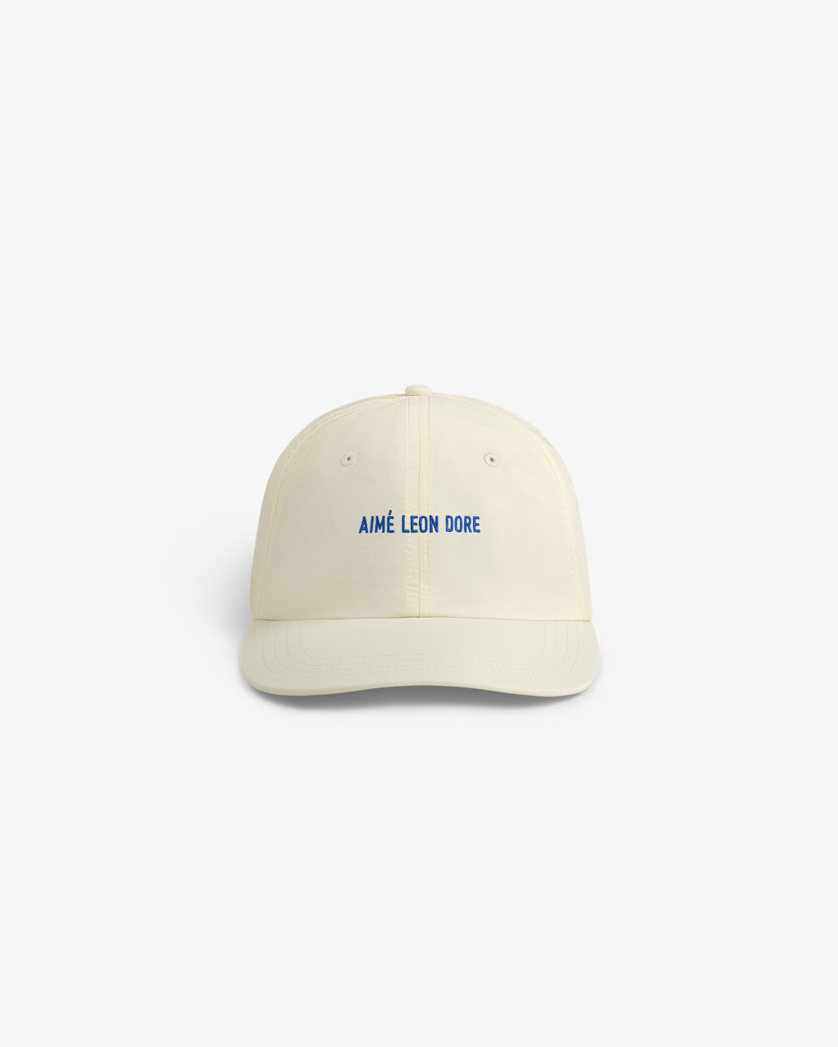 Off-white Nylon Sport Hat with “AMÉ LEON DORE” blue embroidery on front, shown on a white background.
