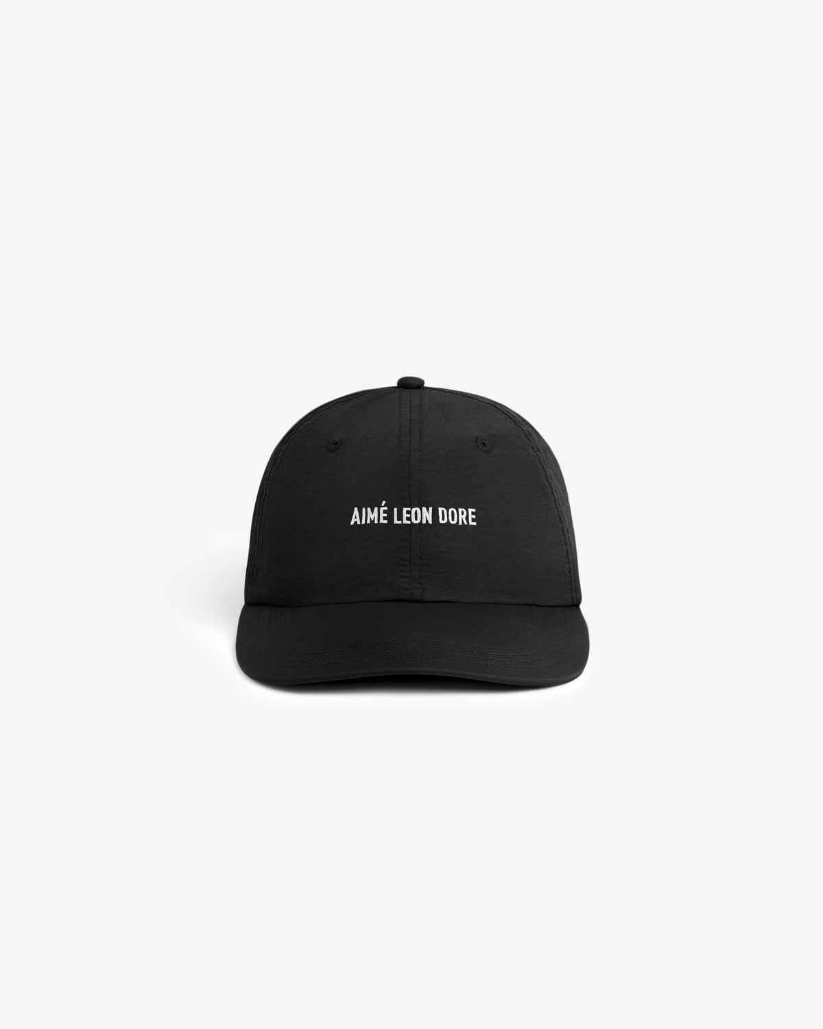 Black Nylon Sport Hat with white AIMÉ LEON DORE text on the front, shown on a plain white background.