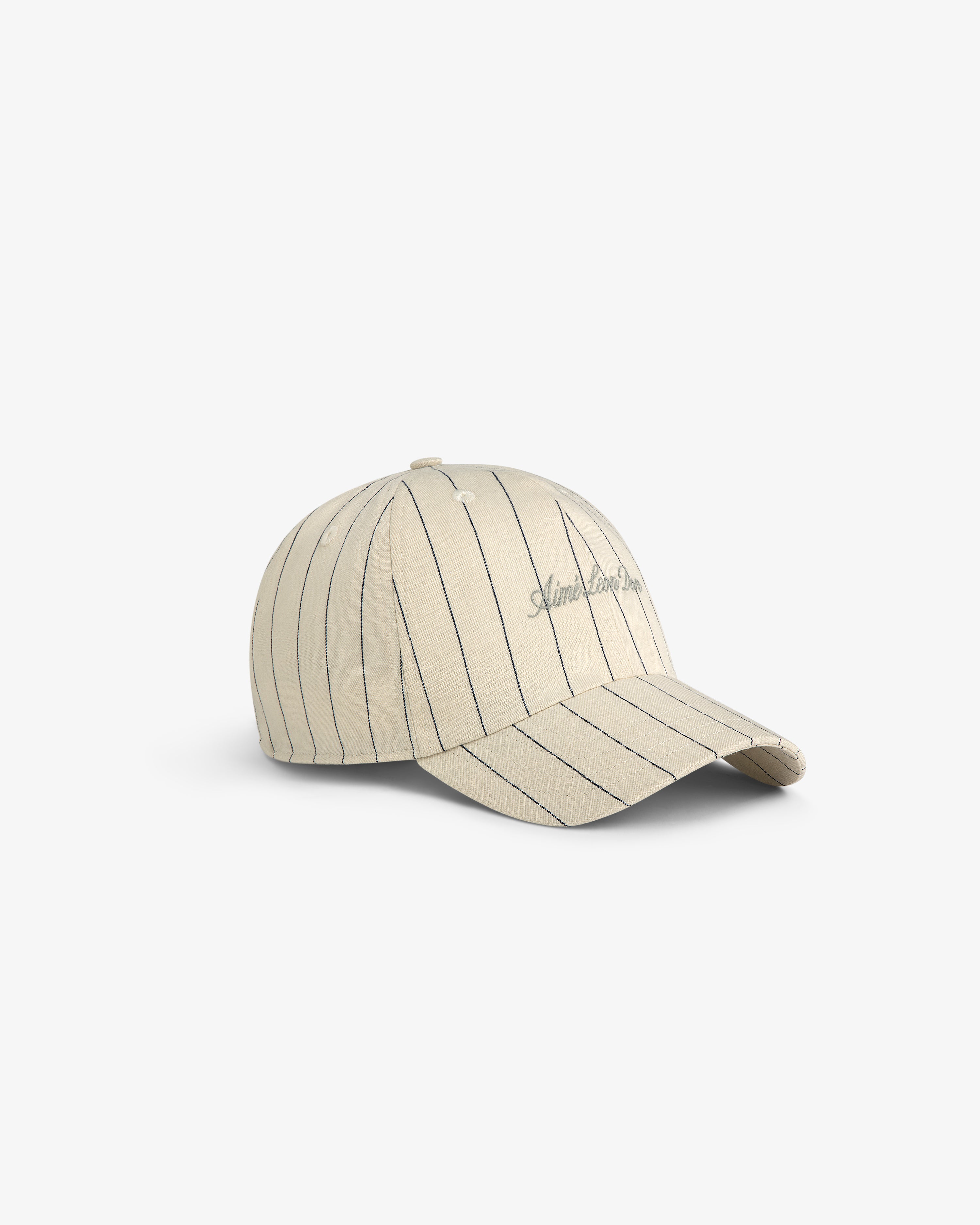 Pinstripe Suiting Hat in beige with thin vertical black stripes and subtle front embroidery, shown on a white background.