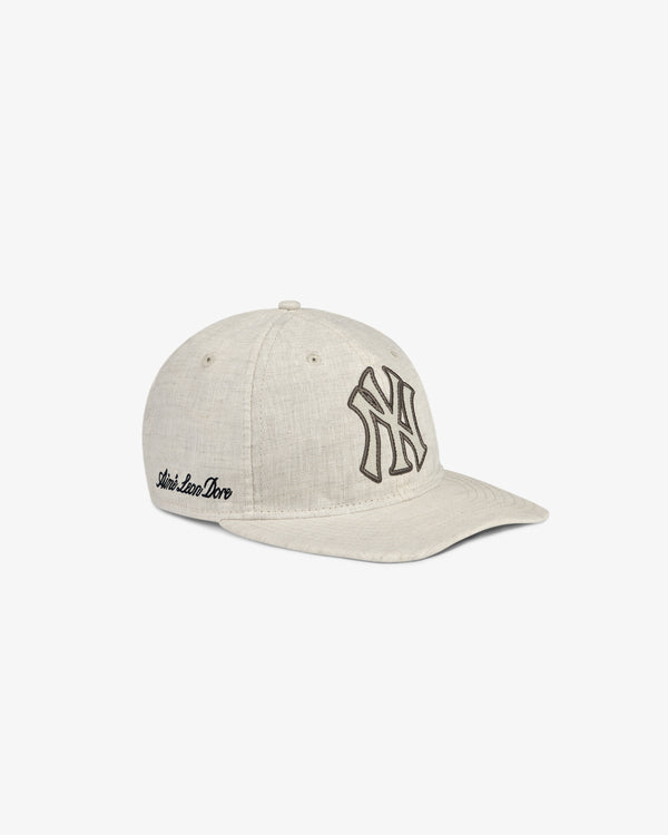 ALD / New York Yankees Retro Fit Hat in light beige with NY logo front and Aimé Leon Dore side embroidery, on white background.