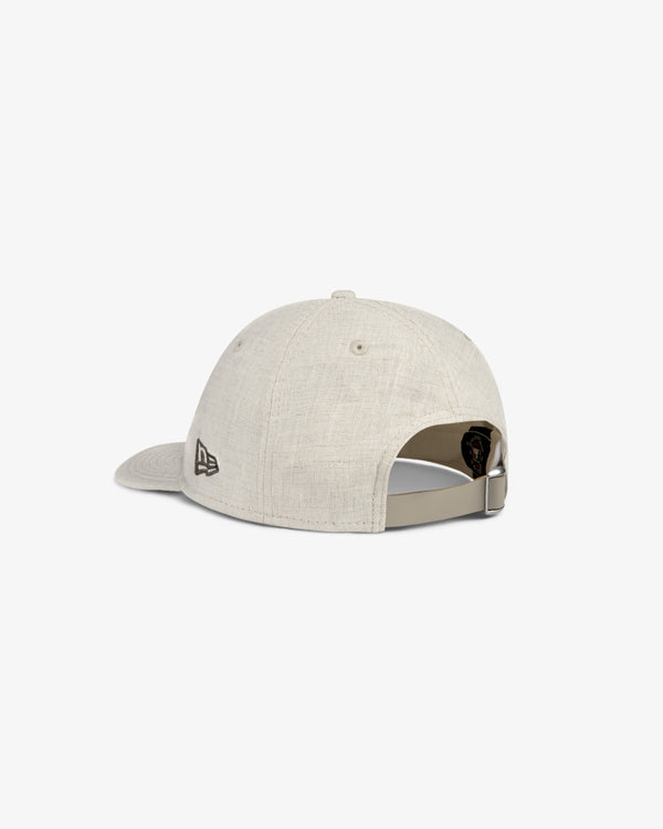 ALD / New York Yankees Retro Fit Hat in beige, shown from the back with a fabric strap and metal buckle closure.