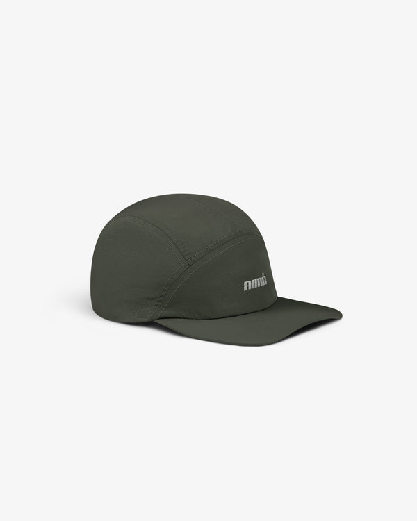 Aimé Performance Sport Hat in dark green with a curved brim and small white embroidered front logo on white background.