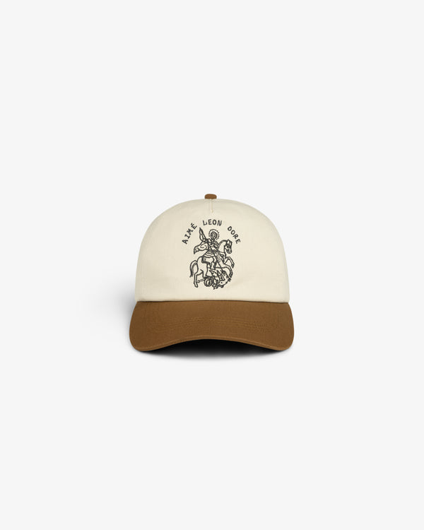 Cream and brown Saint George Logo Hat featuring a rider on a horse and AIME LEON DORE text on the front.