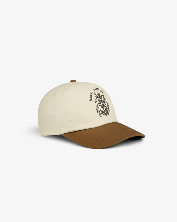 Saint George Logo Hat: beige baseball cap with brown brim, black line art graphic, displayed on white background.
