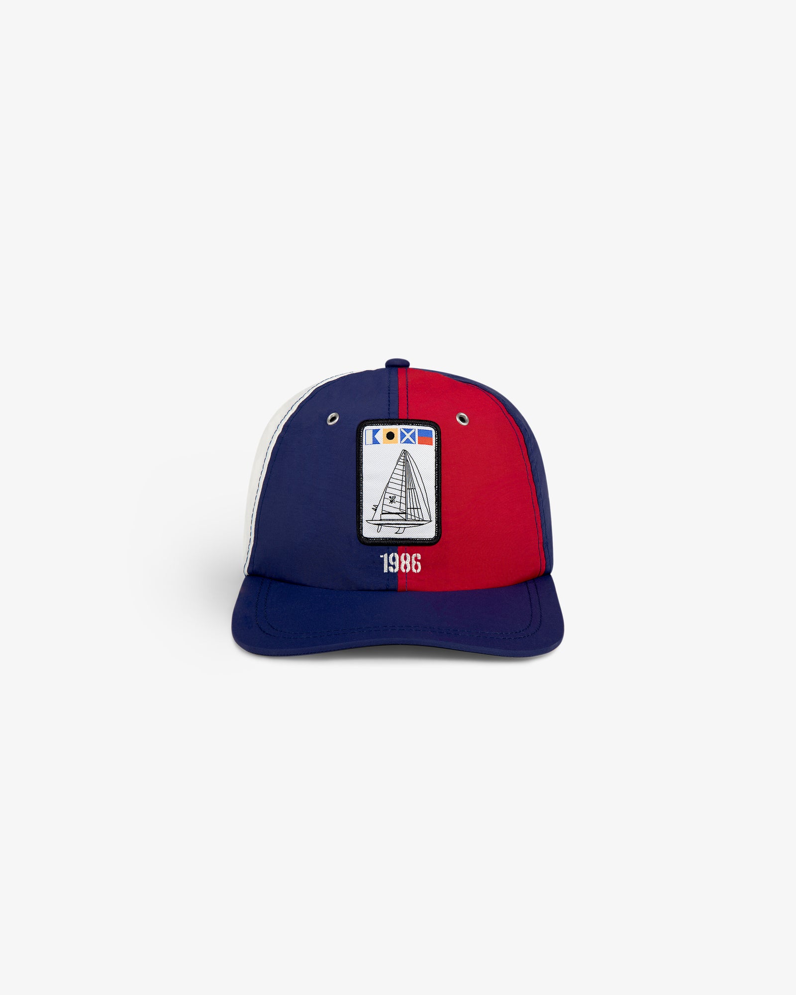 The Nylon Deck Hat is a blue, red, and white cap featuring a sailboat graphic and "1986" on the front.