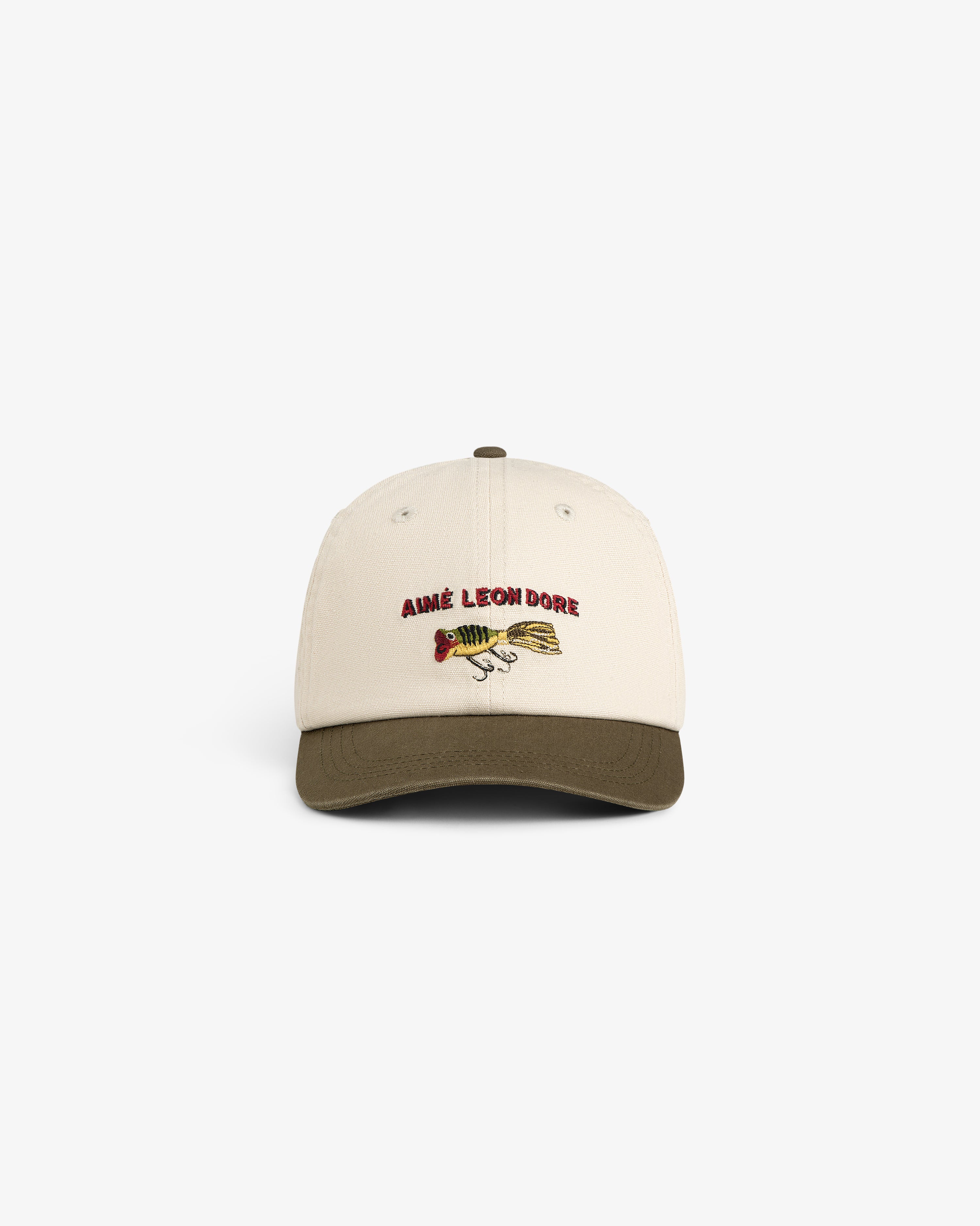 Colorblock Lure Hat: Beige cap with olive brim, AIMÉ LEON DORE text, and fish graphic on the front.