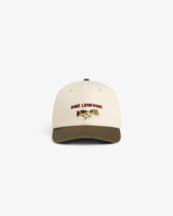 Colorblock Lure Hat: Beige cap with olive brim, AIMÉ LEON DORE text, and fish graphic on the front.