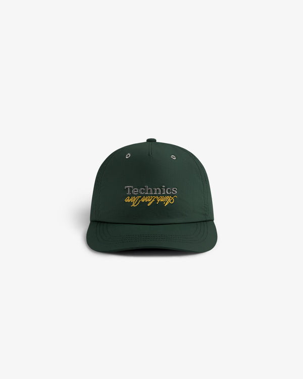 ALD / Technics Nylon Logo Hat in dark green with yellow script embroidered on front, shown from the front.