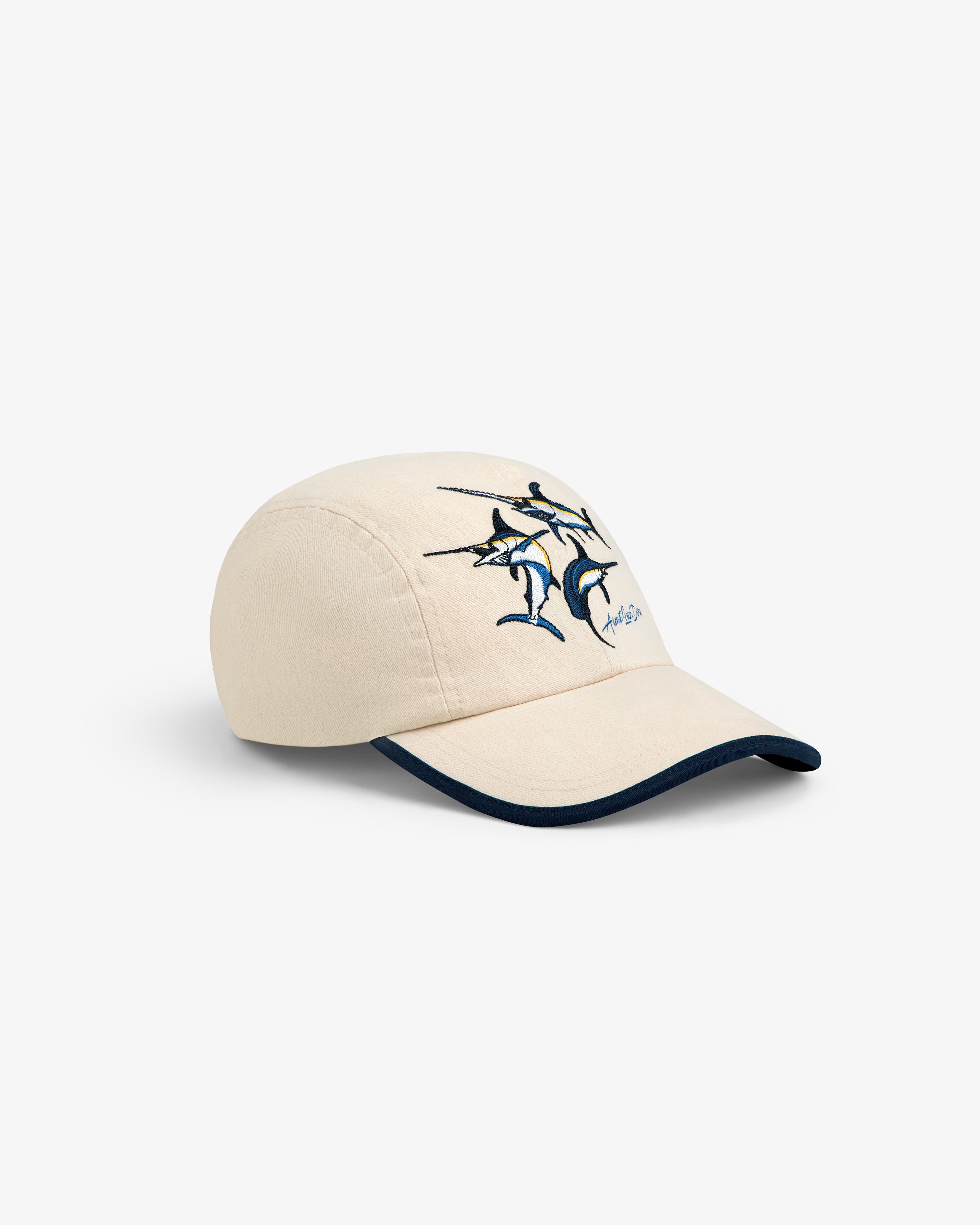 Souvenir Fishing Hat: Beige baseball cap with blue trim, swordfish, and dolphin embroidery on front.