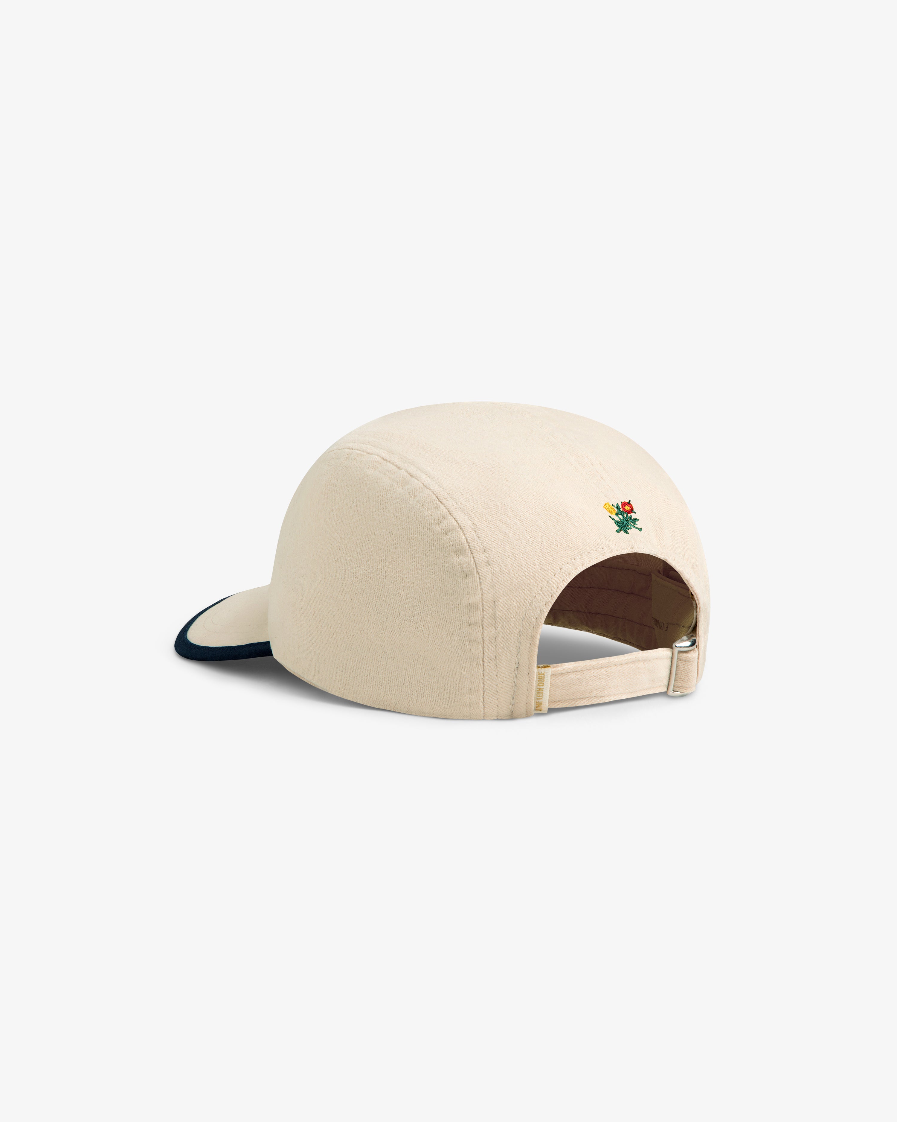 Souvenir Fishing Hat in beige with an adjustable strap and small back embroidery, shown from the rear angle.