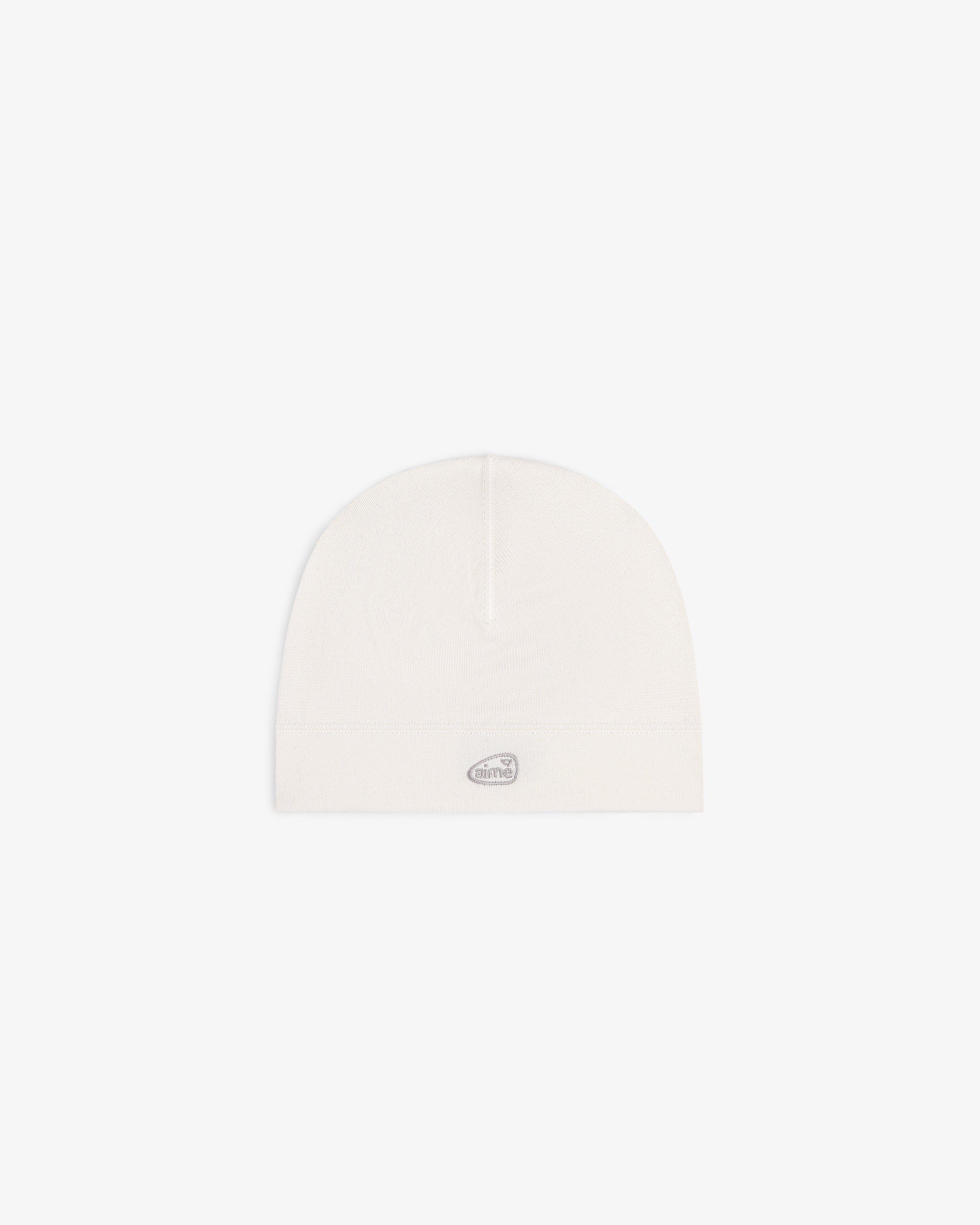 The ALD Golf Skull Cap is a plain white beanie with a small gray oval logo on the front, shown on a white background.