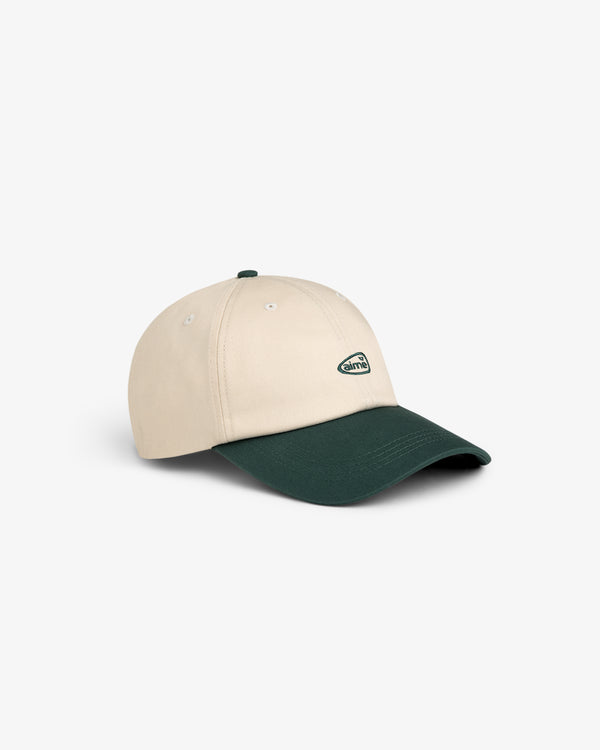 The ALD Golf Logo Hat is beige with a dark green brim and a small oval logo on the front.
