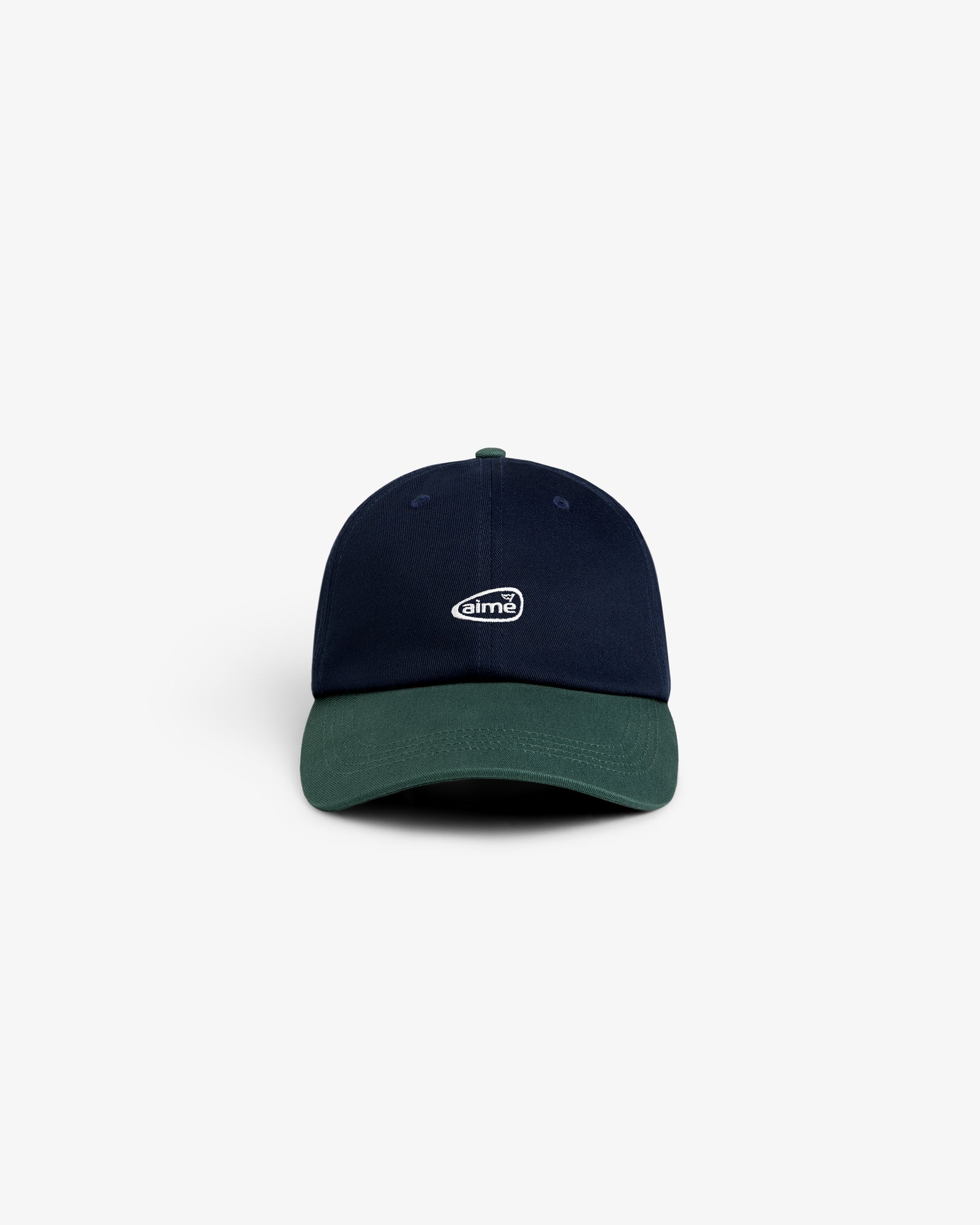 The ALD Golf Logo Hat is a navy blue cap with a dark green brim and a small white oval logo on the front.