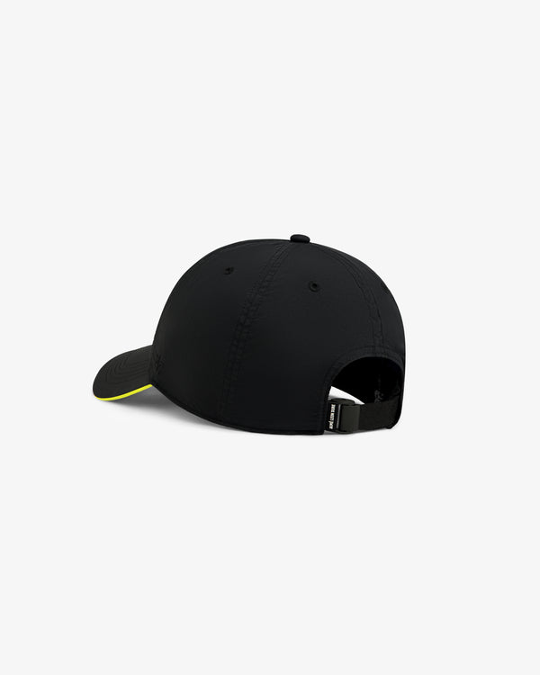 ALD / New Balance Running Hat in black with yellow-edged curved brim, adjustable back strap, and buckle.