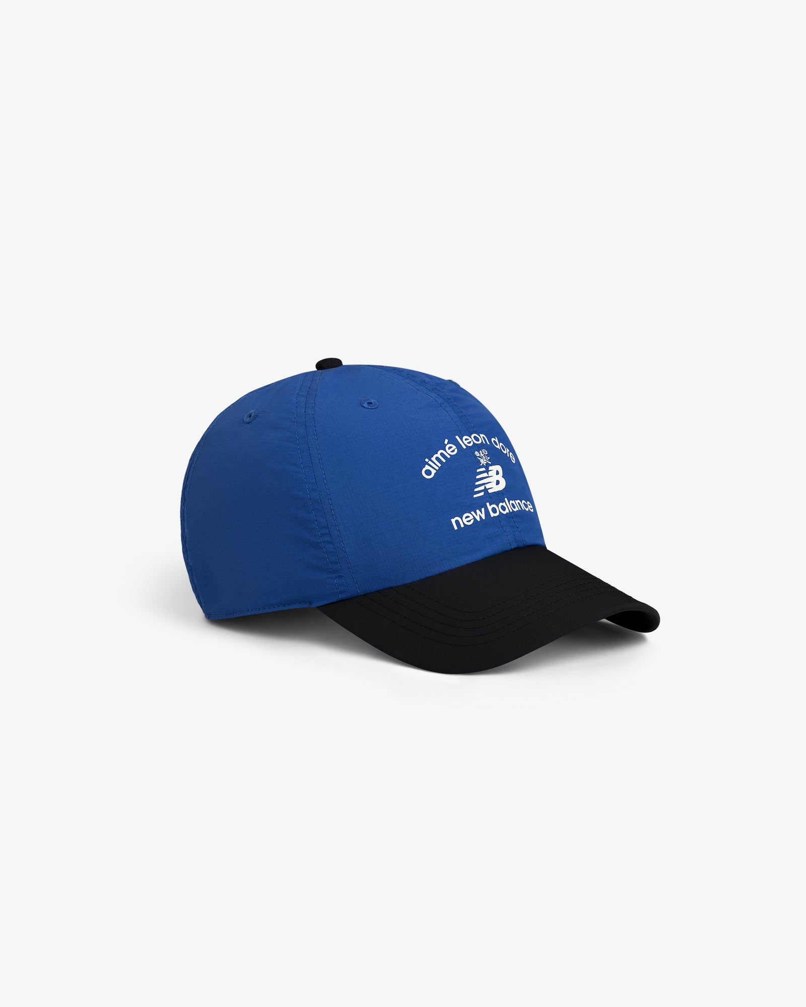 The ALD / New Balance Running Hat is a blue and black cap with white text and logo, shown on a white background.