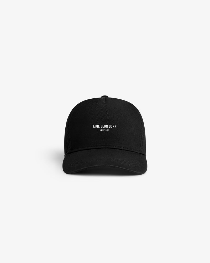 Micro Logo Hat in black with white AIMÉ LEON DORE NEW YORK text on front, shown on a plain white background.
